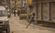 Kashmir Muslims throw stones at Indian government forces near the gun battle site during a...