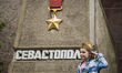 Child celebrates 9th May in Sevastopol near a memorial of the Second World War, Ukraine, o...