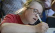 People sign a guestbook at an encampment set up by the Citizens for Solidarity in Action (...