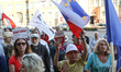 People holding flag of Poland and European Union and Polish constitution in hand are seen...