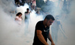 Protesters clash with riot police during a demonstration against the agreement between Gre...