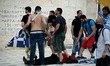 Protesters clash with riot police during a demonstration against the agreement between Gre...