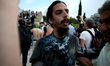 Protesters clash with riot police during a demonstration against the agreement between Gre...
