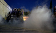 Protesters clash with riot police during a demonstration against the agreement between Gre...