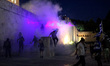 Protesters clash with riot police during a demonstration against the agreement between Gre...