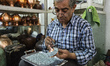 Artist sets mina stones for minakari, unique art of Esfahan, which means decorating metals...