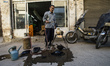 Worker burns cooper pots, Esfahan, Iran