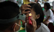 SEMARANG, INDONESIA - OCTOBER 14: Officer conduct a eye examination of a candidate's caree...