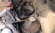  An Afghan man slots and cook dry fruits on a road side Factory in Kabul, Afghanistan,on O...