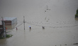 Nepalese people crossing through flood water overflowed from River affected due to incessa...