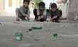 Afghan children play marble in Jalalabad Capital of nangarhar province on October 19, 2014...