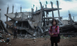 A Palestinian man walks through a neighbourhood destroyed during the 50 day conflict betwe...