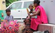 A Family who sells Gift Items near Metro Station waits for the Customers in New Delhi, Ind...