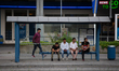 People waiting for the bus at a bus station in Munich. 