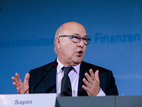 French Finance Minister Michael Sapin reacts during a press conference with German Finance Minister Wolfgang Schaeuble, German Vice Chancell...