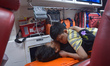 A boy comforts his injured mother in the ambulance after being arrested after illegal immi...