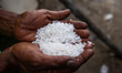 
A farmers with his hand show the salt during a harvest at a salt farm in Banda Aceh, Ind...