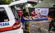 Indonesian police and soldiers evacuate a old man after arriving at Health Facility after...