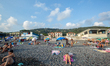 People lying on the beach sun bathing, in Lavagna, Italy, on August 9, 2018. As the hot su...