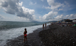 People at the shore. Though the hot temperatures in Italy continue, only a few people comp...