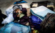 A Palestinian Child waits with his family, hoping to cross into Egypt, at Rafah crossing b...
