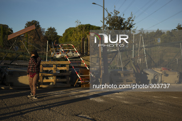 An student stands next to a barricade at the Complutense University during a student strike to protest against the government education refo...