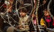 A Palestinian Children wait with his family, hoping to cross into Egypt, at Rafah crossing...