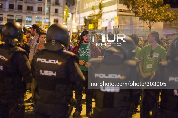 Police in riot gear surround students during a protest against the government education reform and cutbacks in grants and staffing in Madrid...