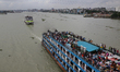 People ride on over-crowded ferries as they rush home to celebrate Eid-al Adha festival wi...