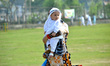 Kashmiri Muslim women holds her baby after Eid-ul-Adha festival Prayers, in Srinagar, the...