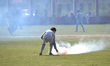 Kashmiri Muslim protestor throws back the teargas canister fired by indian government forc...