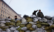 An anti-government protesters stand on a barricade in Kiev early on February 6, 2014. Ukra...