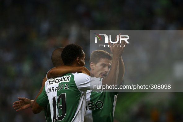 Sporting´s midfielder Adrien Silva (R) celebrates with team mates after a goal of  Maritimo's defender Patrick Bauer (a.g) during the Portug...