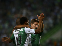 Sporting´s midfielder Adrien Silva (R) celebrates with team mates after a goal of  Maritimo's defender Patrick Bauer (a.g) during the Portug...