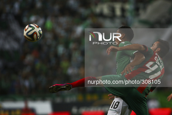 Maritimo's defender Ruben Ferreira (R) vies with Sporting´s forward Andre Carrillo during the Portuguese League football match between Sport...