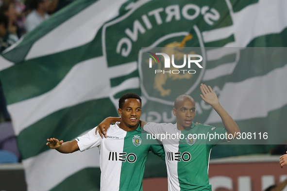 Sporting's forward Andre Carrillo (L) and Sporting's midfielder Joao Mario (R) celebrate the first goal for Sportingduring the Portuguese Le...