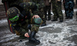 Anti-government opposition activists clean his shoes before march around the "government q...