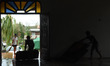 Residents clean up a chapel that served as an evacuation center after Typhoon Mankhut pumm...