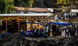 Relatives of miners trapped inside a coal mine flooded with water, wait as search and resc...