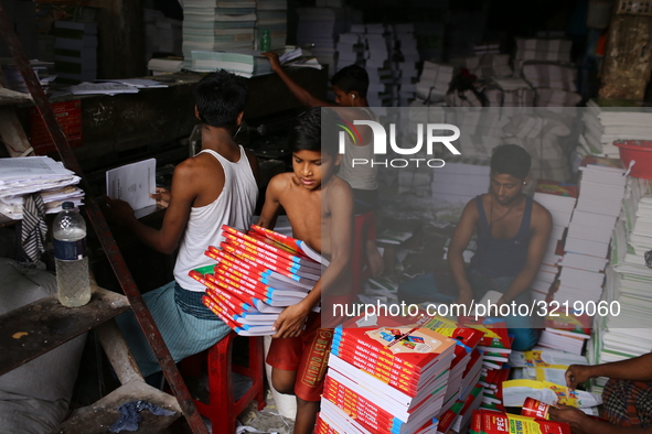 Children are working on a book binding factory in Dhaka, 27 September 2018.  