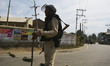 Indian  paramilitary trooper stands guard during curfew like restrictions in downtown area...