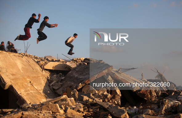 Palestinian youths practise their Parkour skills over the ruins of houses, which witnesses said were destroyed during a seven-week Israeli o...