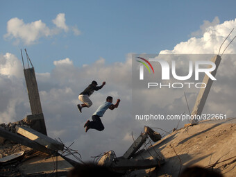 Palestinian youths practise their Parkour skills over the ruins of houses, which witnesses said were destroyed during a seven-week Israeli o...