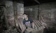 A Palestinian worker kneads mud at one of the largest pottery workshops in the Gaza Strip,...