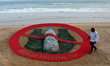 An awareness sand art about stop plastic use is seen at the Bay of Bengal Sea's eastern co...