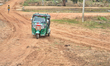 Auto-rickshaw parked on the dirt road leading to the Giant's Tank wildlife sanctuary in Ma...