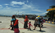  Residents wait to board a military plane for evacuation at the airport in Palu, Central S...