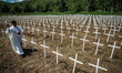 A Catholic priest sprinkles holy water in commemoration of the one year anniversary of Typ...