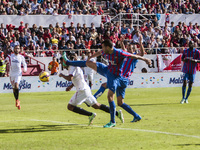 Bacca, player of Sevilla F.C., receives a fault during the match of La Liga (BBVA) between Sevilla FC and Levante UD at the Ramon Sanchez Pi...