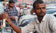Vendor selling water waits for the customers near his water trolley infront of Red Fort in...